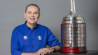 Luis Roberto, narrador da Globo, ao lado da Taça Libertadores