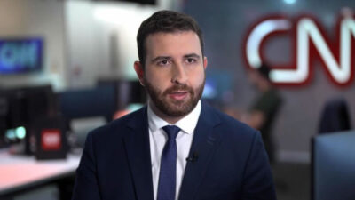 Teo Cury de terno e gravata na redação da CNN Brasil durante participação como analista de Política e Judiciário