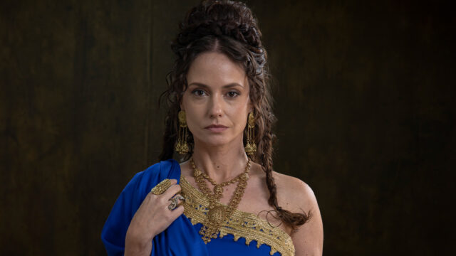 Rosanne Mulholland caracterizada como Agripina com vestido azul e joias douradas em imagem promocional da novela Paulo, o Apóstolo da Record