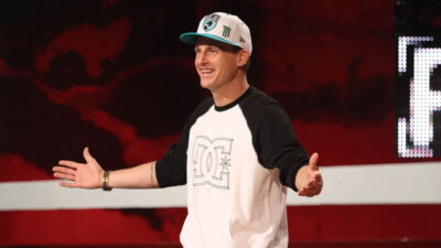 O apresentador Rob Dyrdek com boné e camisa raglan sorri e gesticula no palco de gravação do programa Ridiculousness, da MTV