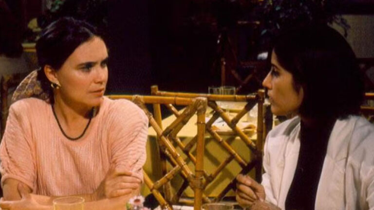 Regina Duarte como Raquel Accioli e Gloria Pires como Maria de Fátima em cena da novela Vale Tudo, Raquel veste blusa rosa e Fátima usa casaco branco