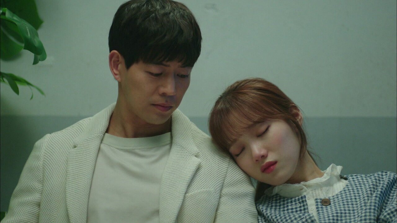 Lee Sung Kyung como Choi Michaela e Lee Sang yoon como Lee Do ha aparecem sentados próximos em um banco de madeira no dorama sul coreano Questão de Tempo
