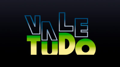 Logotipo da novela Vale Tudo com letras estilizadas, palavra Vale em azul degradê na parte superior e palavra Tudo em verde e amarelo abaixo
