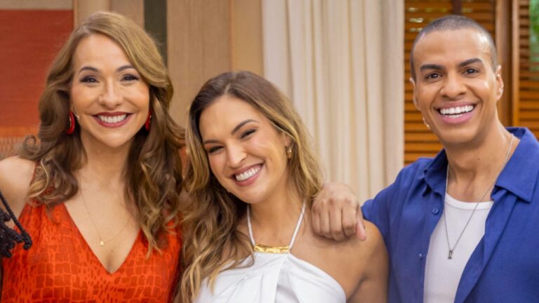 Maria Beltrão Talitha Morete e Thiago Oliveira sorrindo juntos no estúdio do programa É de Casa em ambiente interno iluminado