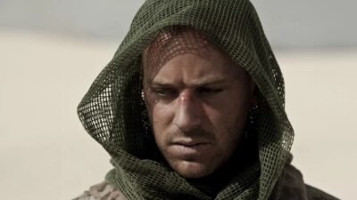 Michael Stevens (Armie Hammer) com expressão tensa e rosto coberto por tecido de malha em cena de Campo Minado